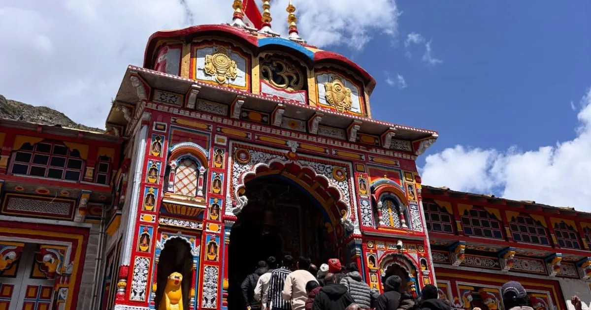 Char Dham Yatra Registration, Route Map, Itinerary, Packages & Helicopter Booking 9 The vibrant, multi-colored main entrance façade of the shrine decorated with ornate carvings as pilgrims gather beneath a blue sky.
