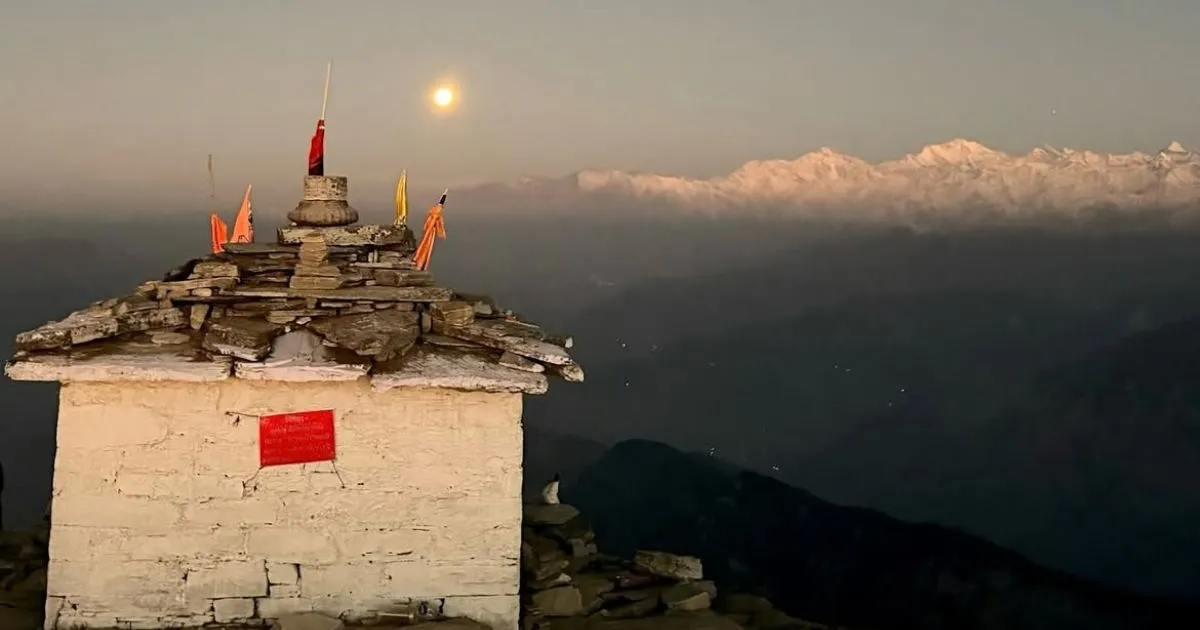 12 Best Places to Visit in Uttarakhand in October for Nature Lovers 12 A small whitewashed stone shrine on a high ridge overlooking snowy Himalayan ranges in Chopta.