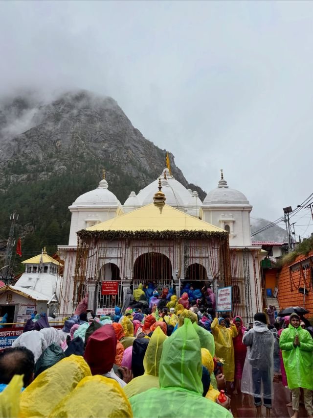 Visit Harsil Valley: How to Reach, Near Hotels, Best Time | Complete Travel Guide 13 Many pilgrims in raincoats visit a white temple during a rainy day near Harshil.