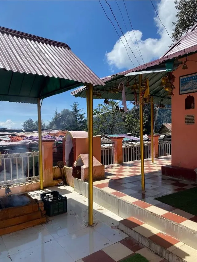 Nachiketa Tal Trek: A Complete Guide With Route Map and Tips 4 The sunny outdoor courtyard of Guru Chaurangi Nath Temple showing tiled floors and gold-painted pillars.