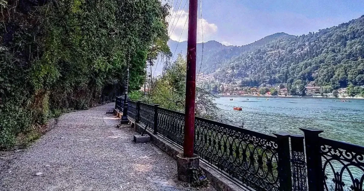 12 Best Places to Visit in Uttarakhand in October for Nature Lovers 1 A paved lakeside walking path with decorative iron railings running beside Naini Lake in Nainital.